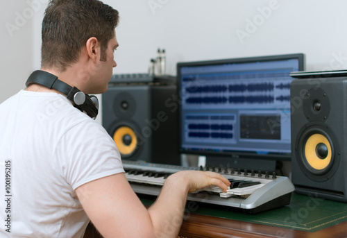 Male sound producer working in recording studio.