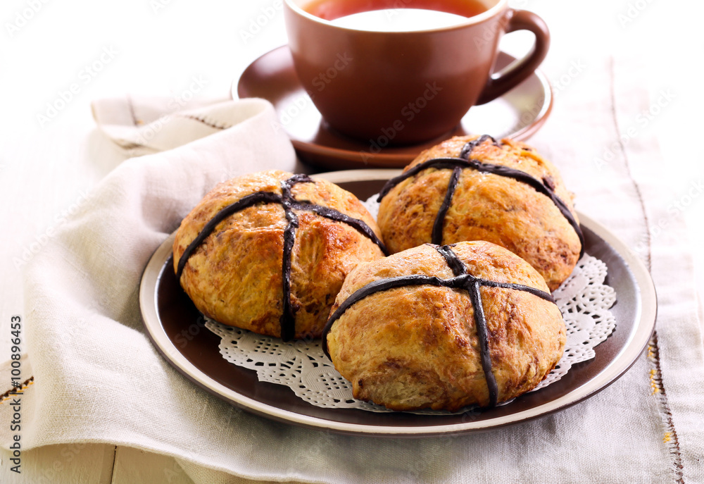 Chocolate hot cross buns on plate Chocolate hot cross buns on plate