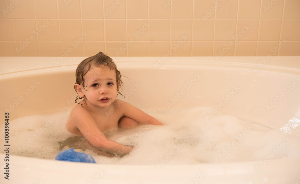Young boy enjoys a bubble bath at home in a soaking tub Young boy enjoys a bubble bath at home in a soaking tub