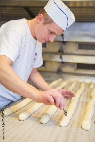 baker making bread with his hands