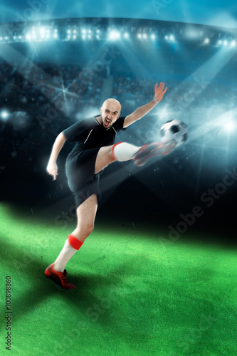 Man playing soccer and shooting a ball in the game