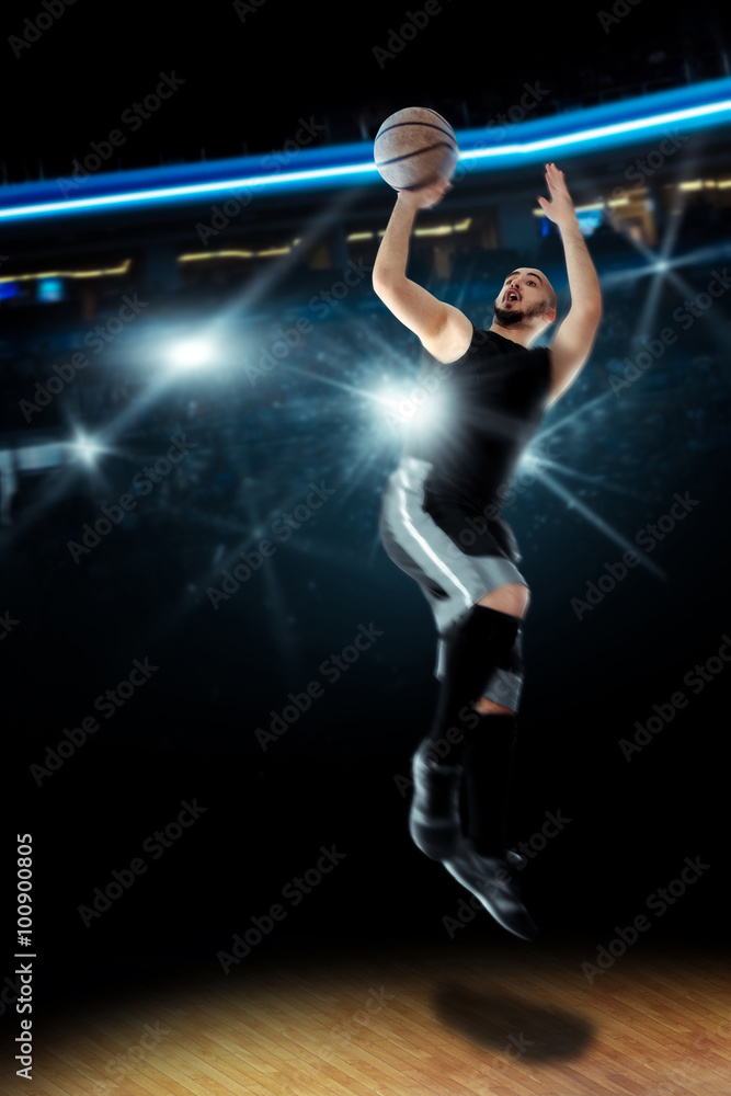 Basketball player in action shoots a ball into the ring