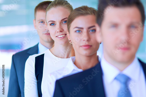 Smiling successful business team standing in office