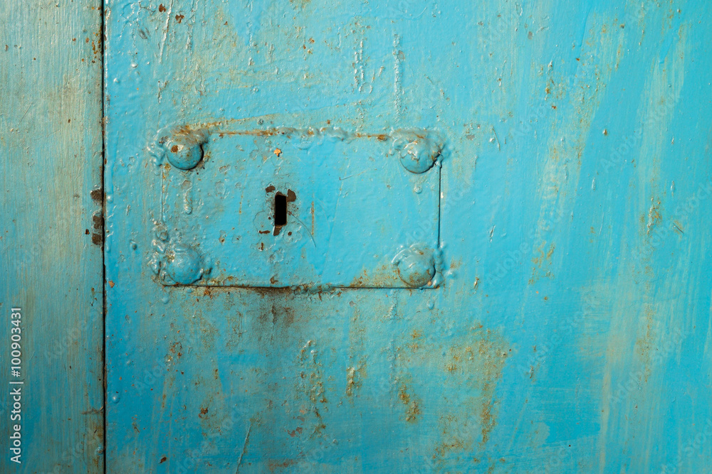 keyhole on metal doors painted in blue keyhole on metal doors painted in blue