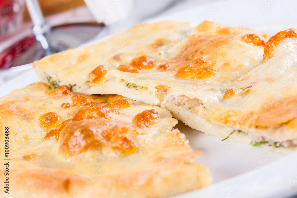 Khachapuri with meat on white plate