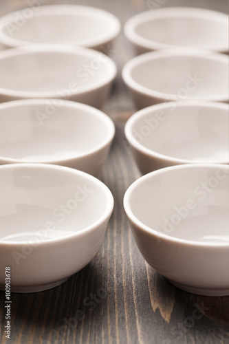 Two rows of white ceramic bowls