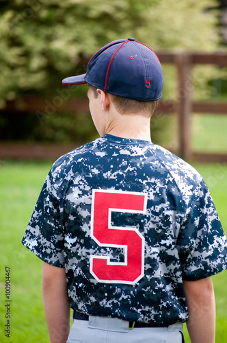 Baseball boy outside from behind in camo jersey