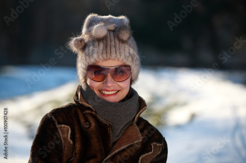 Beautiful woman with a bobble hat and sunglasses