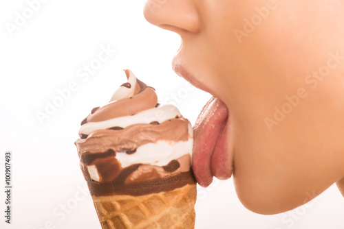 Photos Young girl licking an ice cream.