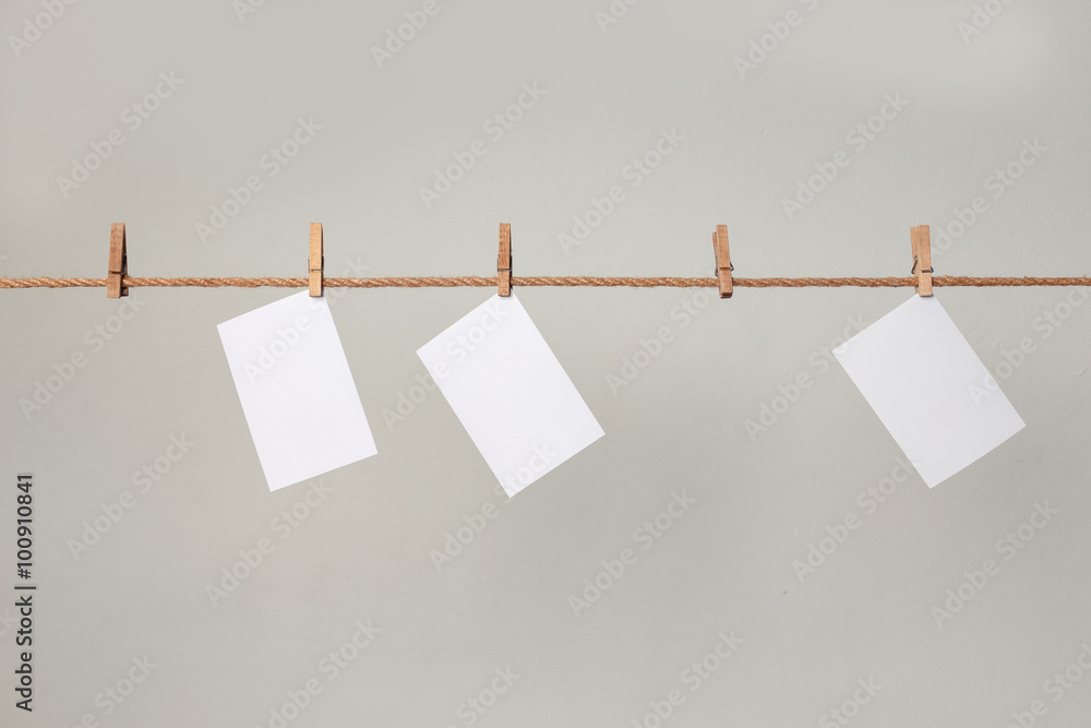 white photo paper. Hanging on a clothesline with clothespins. white photo paper. Hanging on a clothesline with clothespins.