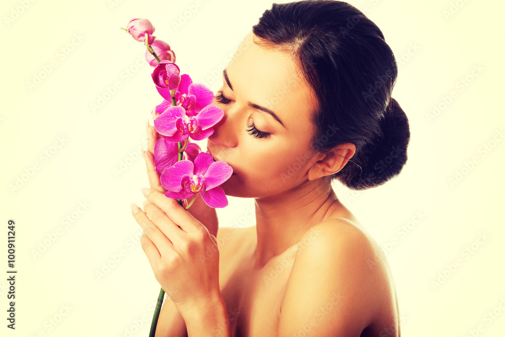 Fototapeta premium Topless woman with purple orchid branch