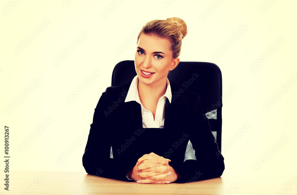 Young beautiful happy businesswoman behind the desk Young beautiful happy businesswoman behind the desk