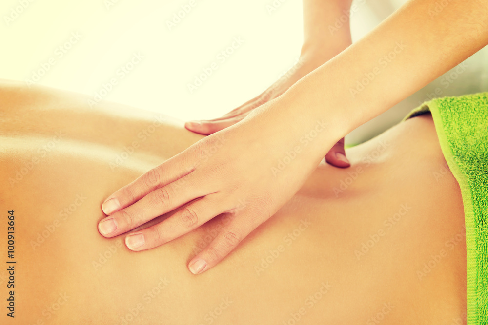 Fototapeta premium Young woman is being massaged. 