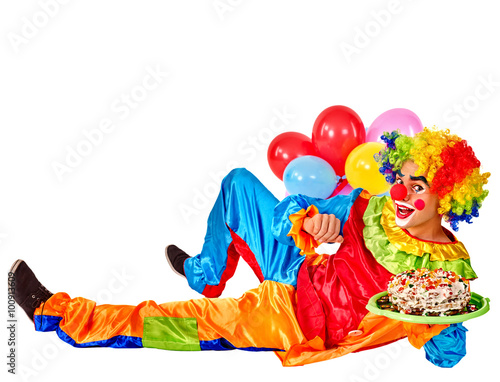 Happy birthday clown holding cakes and bunch of balloons lying on floor.  Isolated.