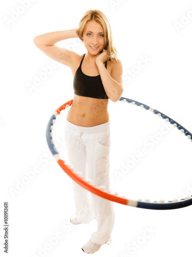 sporty fit girl doing exercise with hula hoop. © Voyagerix