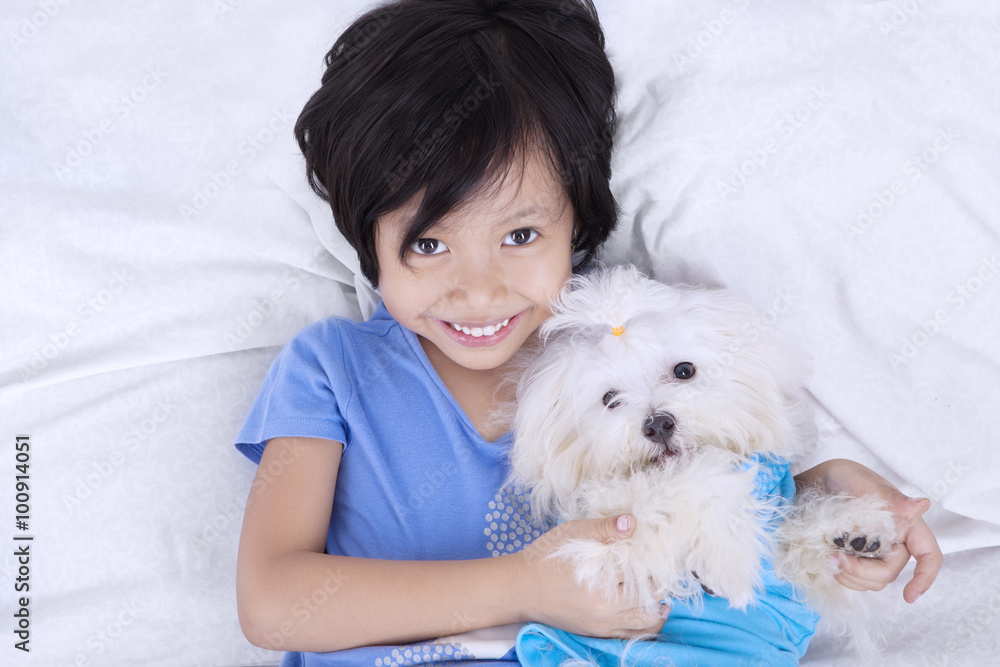 Closeup of girl and dog on bed Closeup of girl and dog on bed