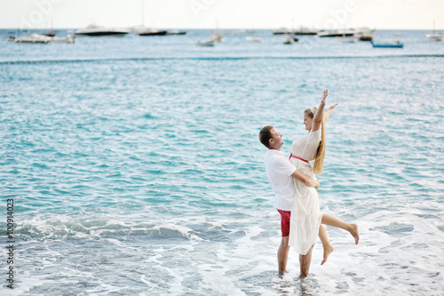 happy couple on the beach of Positano, Amalfi coast, Italy