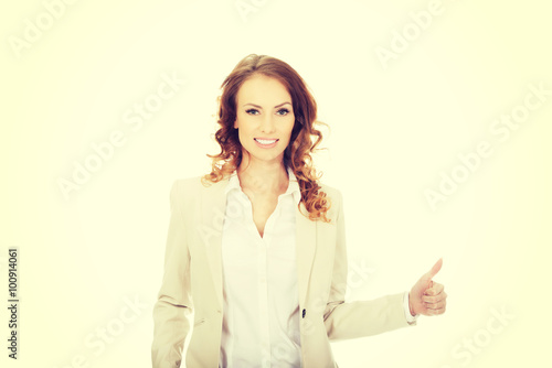 Businesswoman with thumbs up gesture.