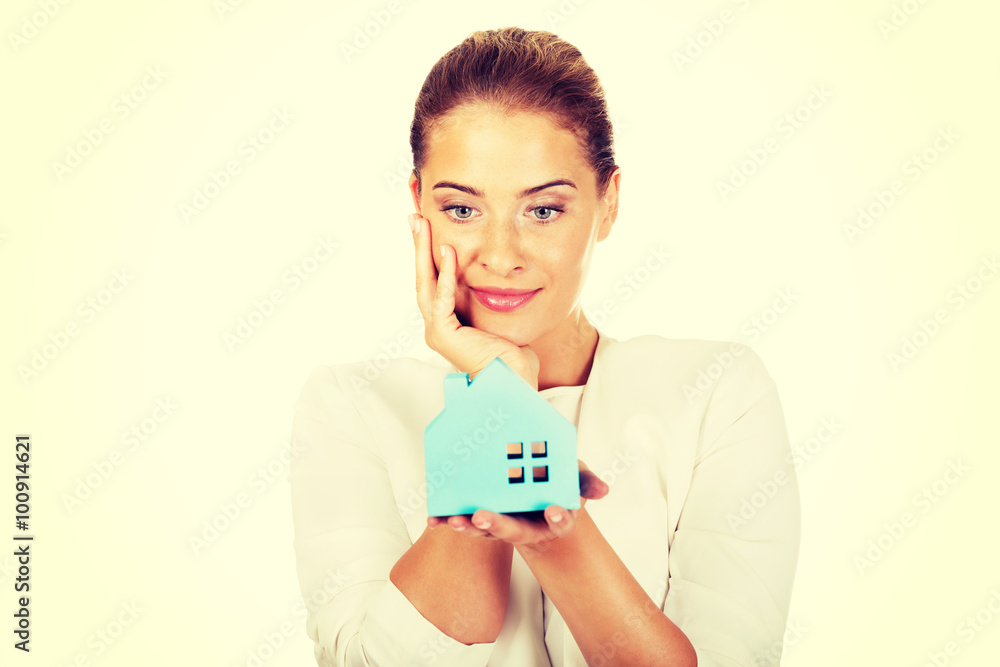 Smile businesswoman holding a paper house Smile businesswoman holding a paper house