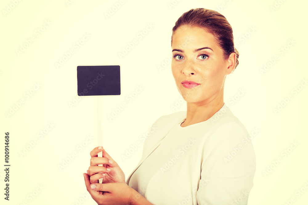 Young businesswoman holding small empty advertising board Young businesswoman holding small empty advertising board