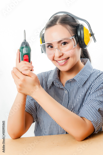 Young woman with a drill