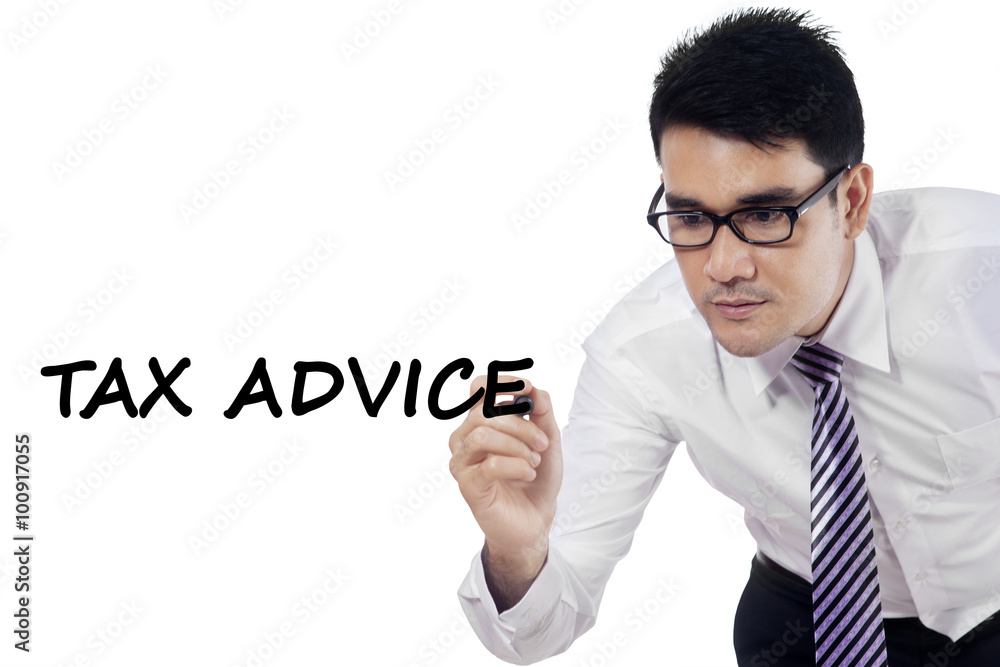 Male worker writes tax advice on whiteboard Male worker writes tax advice on whiteboard