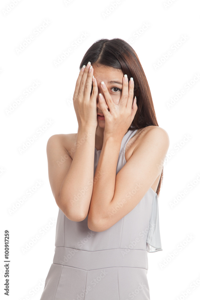 Beautiful young Asian woman peeking through fingers Beautiful young Asian woman peeking through fingers