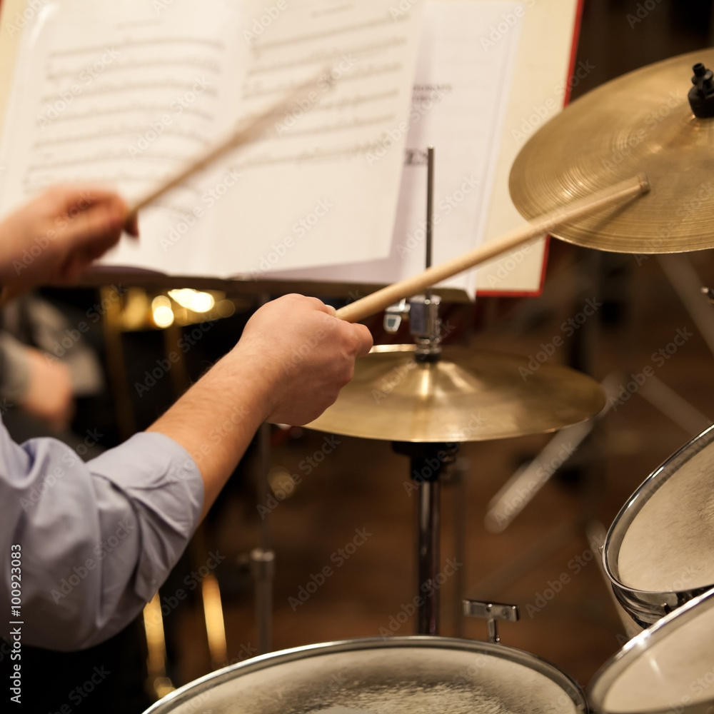 Hands of a man playing a drum set in motion Hands of a man playing a drum set in motion
