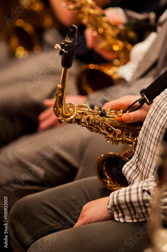 Photography Fragment of a saxophone in the hands of a musician in a jazz orchestra