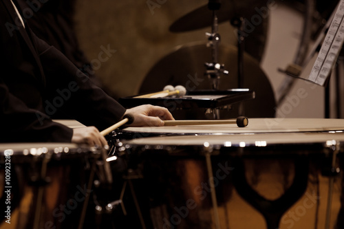 Hands musician playing timpani in dark colors closeup photo