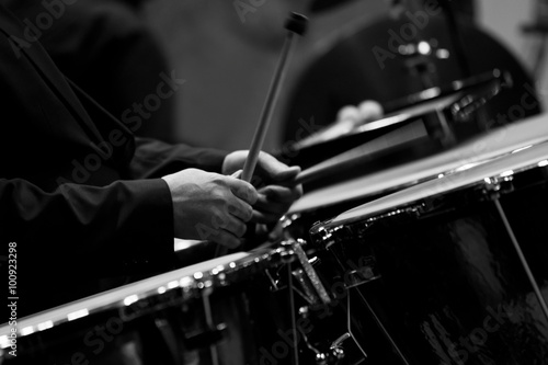 Hands musician playing timpani closeup in black and white