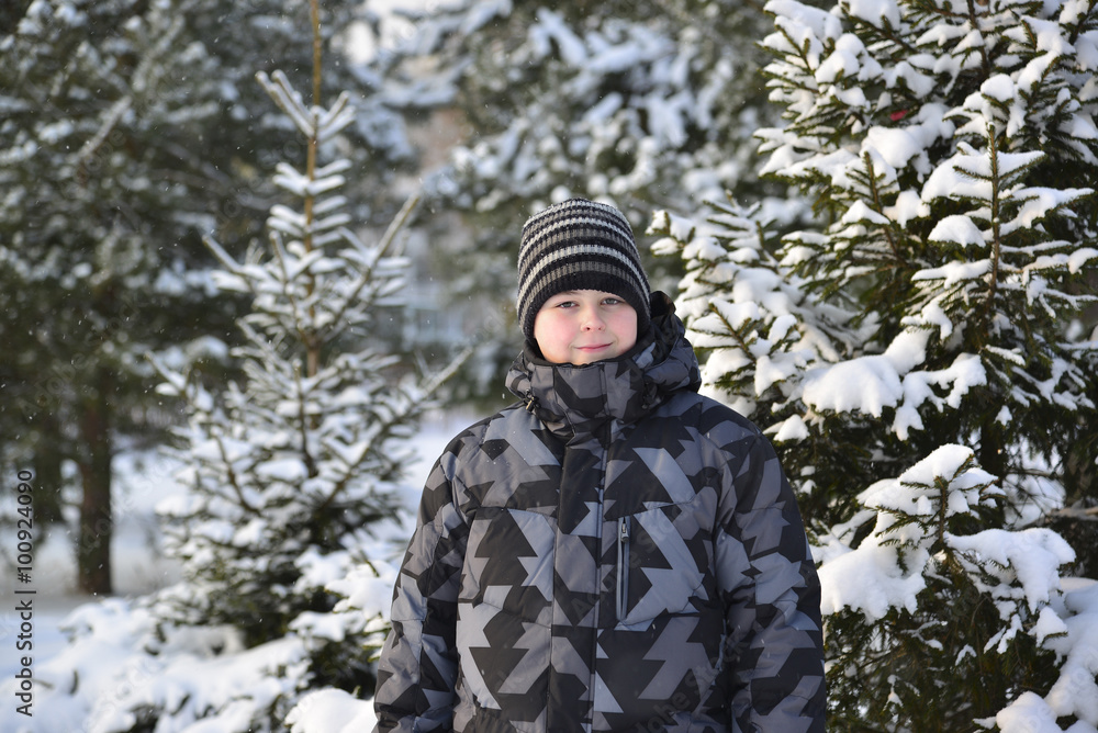 teenage boy at a pine forest in winter