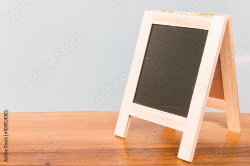 Empty Chalkboard on wooden board and gray background
