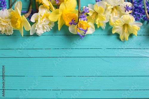 Fototapeta Naklejka Na Ścianę i Meble -  Border from yellow and blue  flowers on green  painted wooden pl