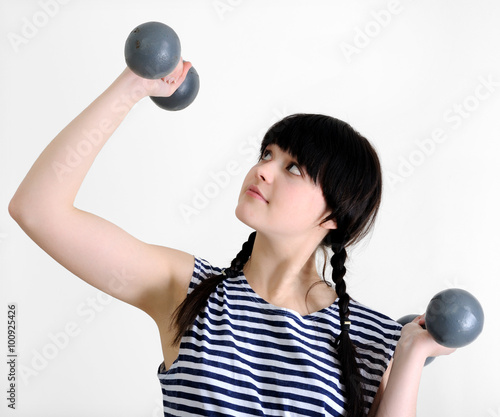 young woman with two old dumbbells