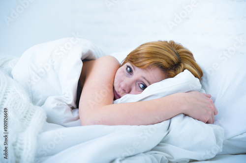 young woman lying in bed sick unable to sleep suffering depression and nightmares insomnia sleeping disorder