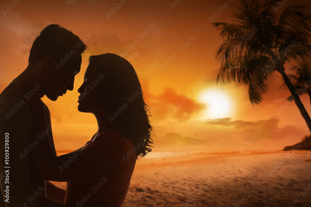 Young couple silhouette on a beach