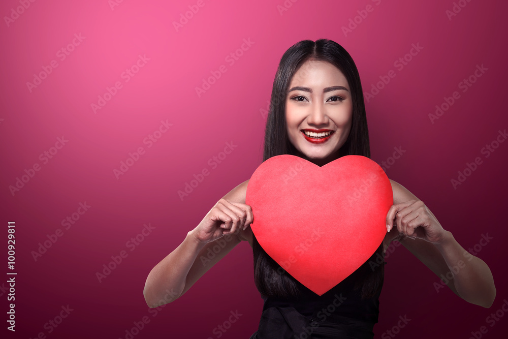Pretty asian woman holding red paper with heart shape Pretty asian woman holding red paper with heart shape