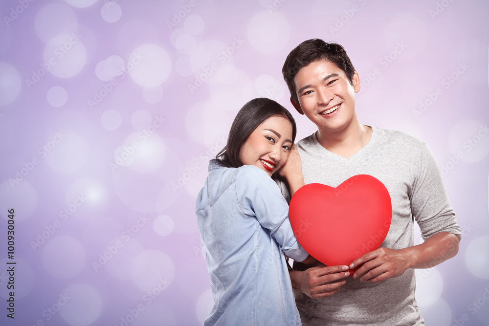 Lovely couple holding red heart Lovely couple holding red heart