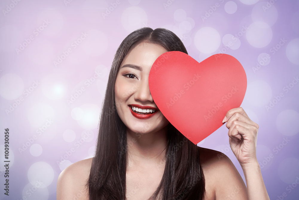 Pretty asian woman holding red paper with heart shape Pretty asian woman holding red paper with heart shape