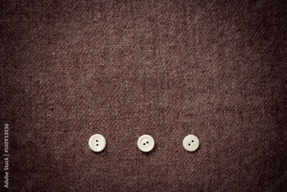 .background of wool fabric and three buttons .background of wool fabric and three buttons