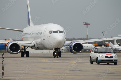 Airplane taxiing after Follow me car