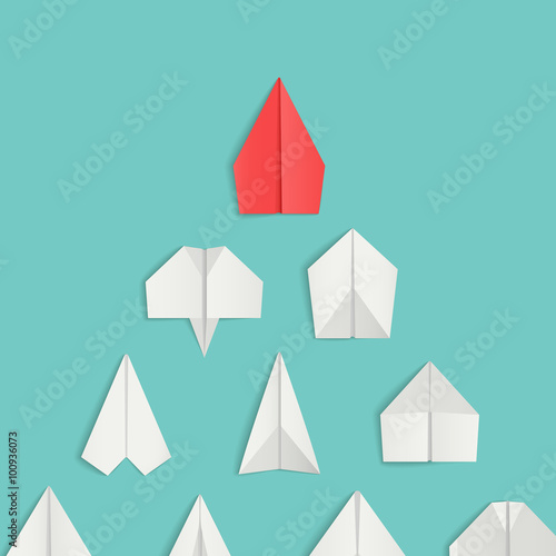 Leadership concept with red paper airplane leading among white. 