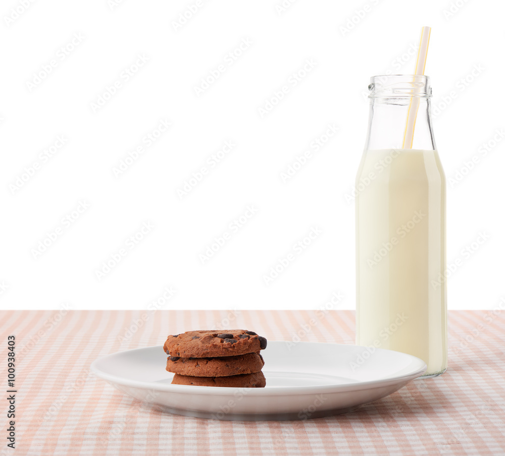 Chocolate chip cookies on white plate and bottle of milk Chocolate chip cookies on white plate and bottle of milk