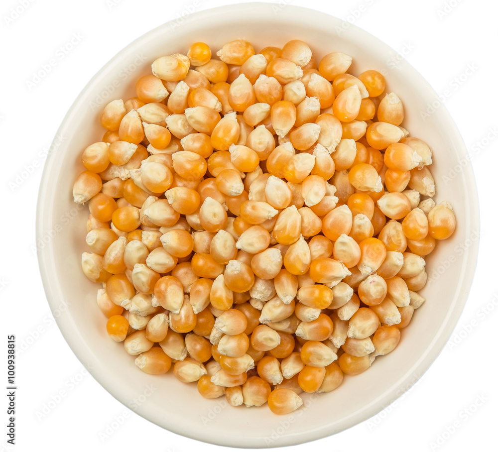 Raw popcorn in white bowl over wooden background Raw popcorn in white bowl over wooden background