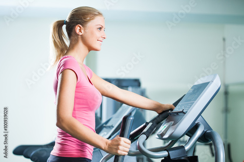 Woman exercising on treadmill in gym