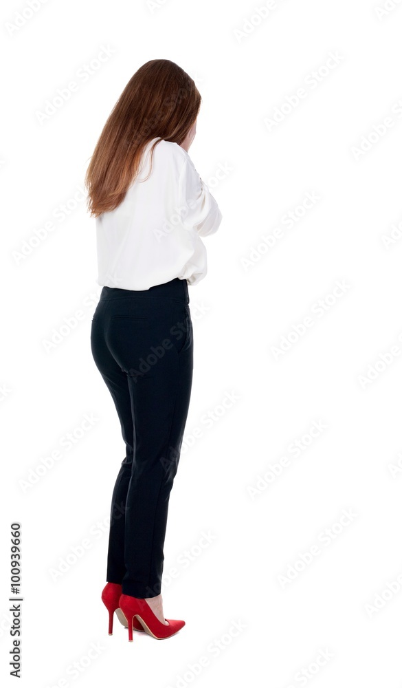 Back view of shocked woman in trousers. Back view of shocked woman in trousers.