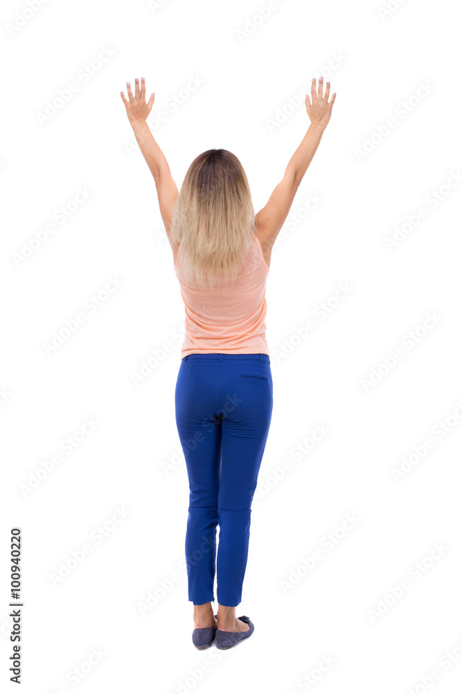 Back view of  joyful woman celebrating victory hands up.