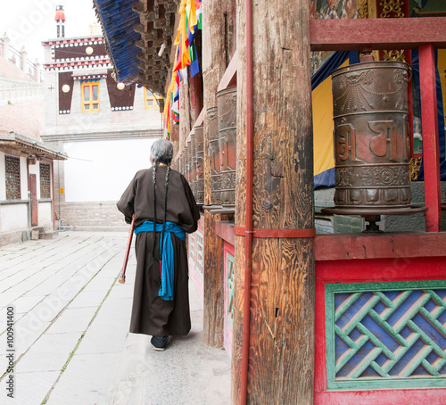 one female Tibetan prays at Kumbum Monastery in Qinghai Province, China. © cindyxiong