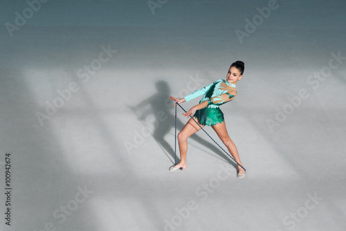 gymnast in costume performs exercises with rope